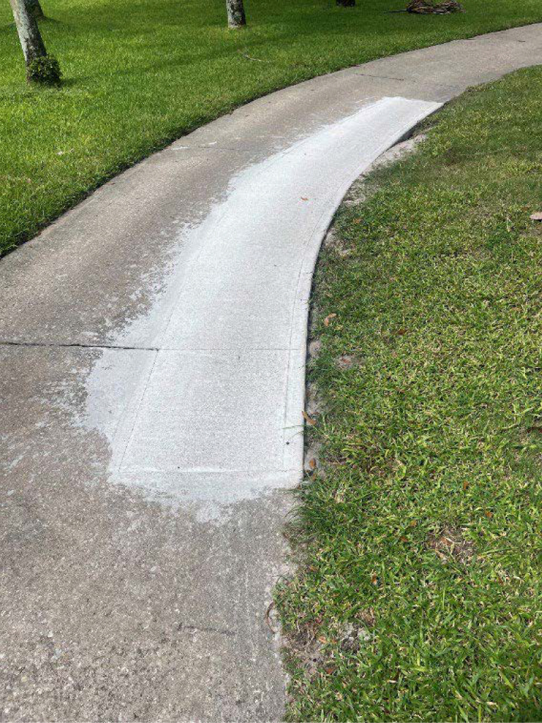 A concrete path with a freshly resurfaced  section in the middle.